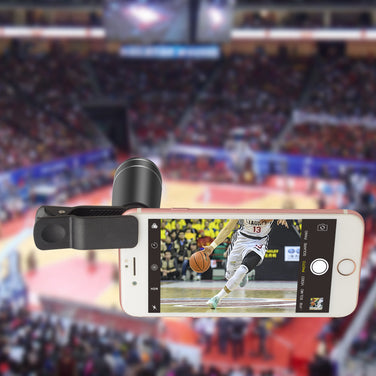 Smartphone with a camera lens attachment displaying a basketball game in an arena.