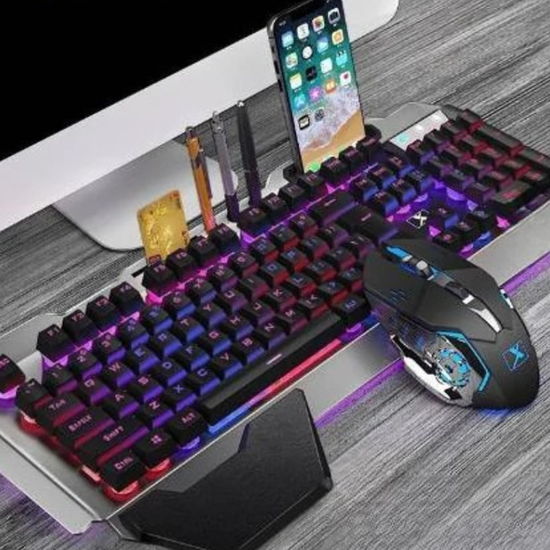 Ergonomic Mechanical Keyboard with RGB Backlight placed on a desk with gaming mouse and smartphone.