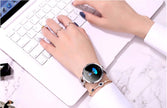 Fashionable Women's Smart Watch on a woman's wrist while typing on a laptop, showcasing style and technology.