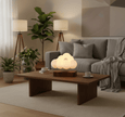 Glowing Cloud Light illuminating a cozy living room with a wooden table and plants.