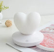 GlowTouch Desk Lamp in heart shape design, providing soft illumination and modern style for any space.