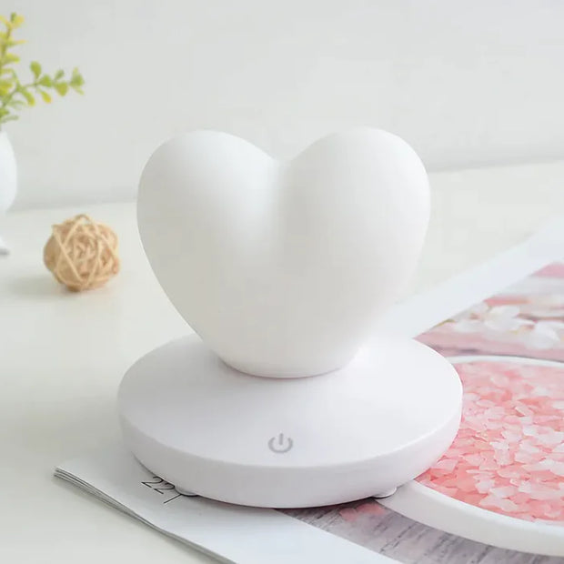 GlowTouch Desk Lamp in heart shape design, providing soft illumination and modern style for any space.