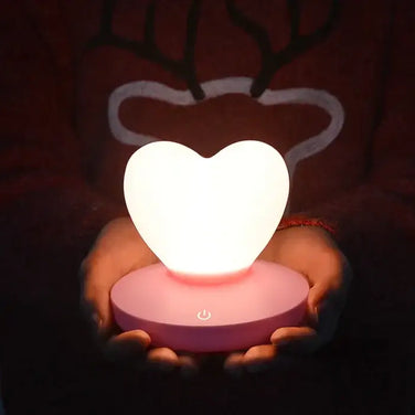GlowTouch Desk Lamp featuring a heart-shaped light held by hands, providing soft illumination and modern charm.