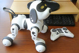 Intelligent Remote Control Robot Dog with controller on desk, ideal for interactive play and emotional development.