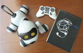Intelligent Remote Control Robot Dog with game controller and notepad on wooden table.