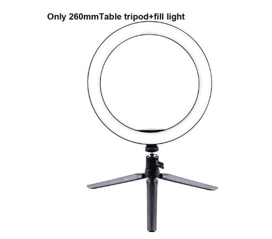 LED Ring Light on a table tripod, providing soft illumination for photography and video calls.