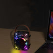 Mech Bluetooth Speaker Creative Saibo with vibrant lights on a table beside a laptop.