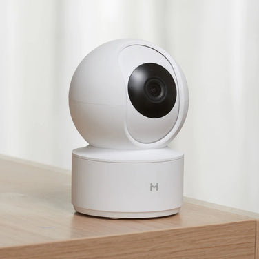 Smart Home Eye Guard high-definition surveillance camera on a wooden table.