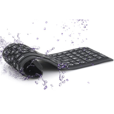 Bluetooth folding silicone keyboard with water splashes, showcasing its durability and flexibility.