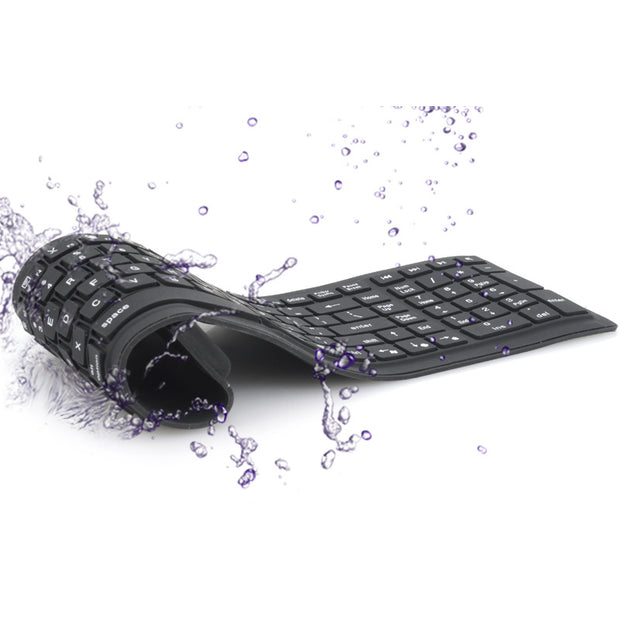 Bluetooth folding silicone keyboard with water splashes, showcasing its durability and flexibility.