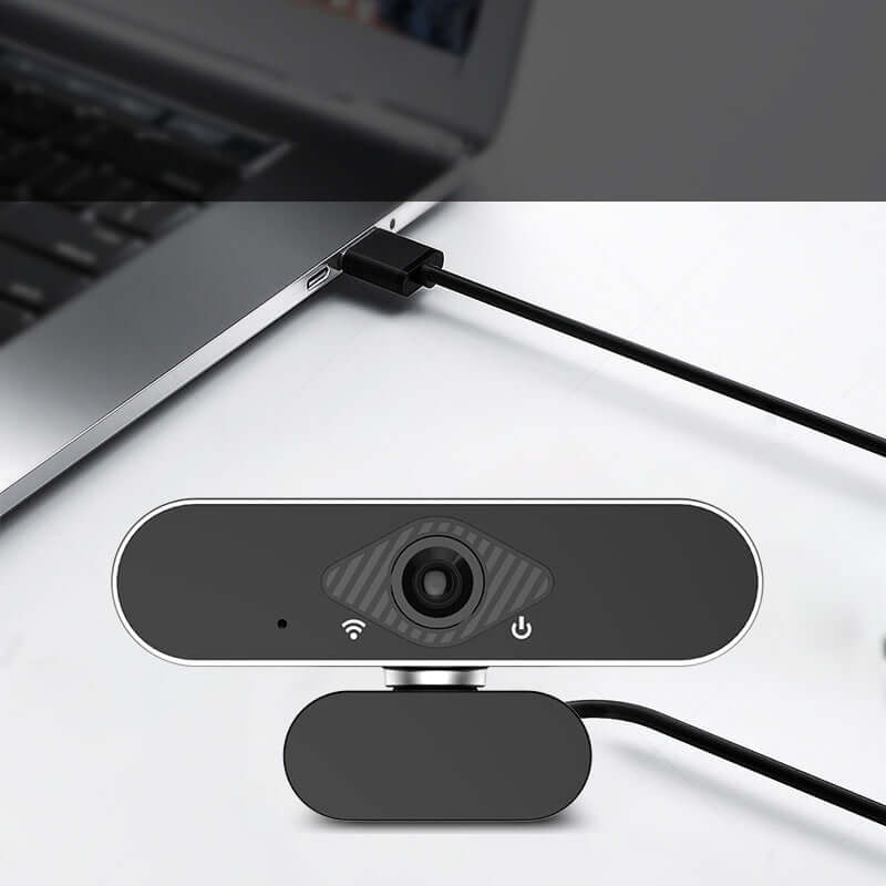 Webcam with microphone connected to a laptop, ideal for video calls and online meetings.