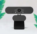 Webcam with microphone featuring sleek design and integrated audio for clear video calls.