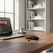 Wireless Bluetooth 5.0 Silent Mouse on a desk next to a laptop in a bright, modern workspace.