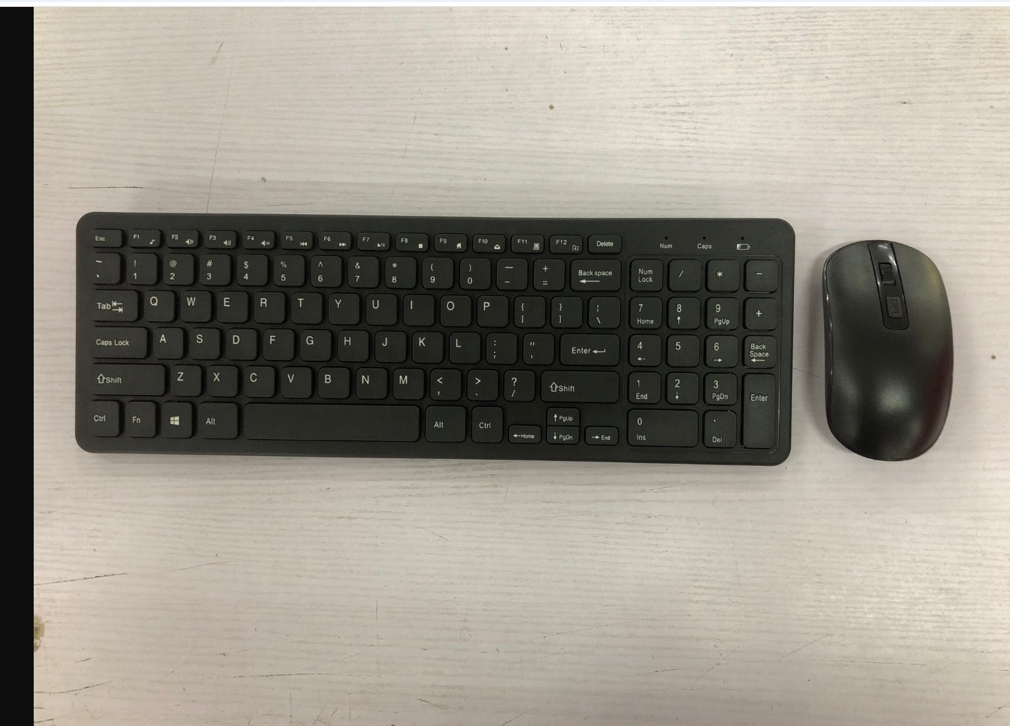 Wireless Keyboard and Mouse Set positioned on a clean surface, showcasing the sleek black design.